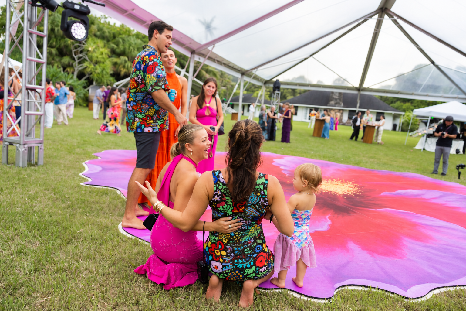 Guests and a young child gathering at the edge of the hibiscus dance floor